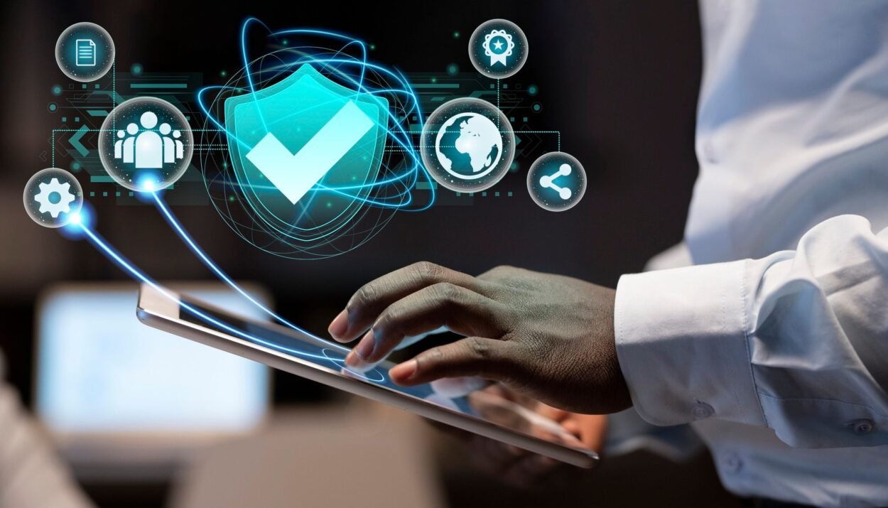 Person using tablet with security icons